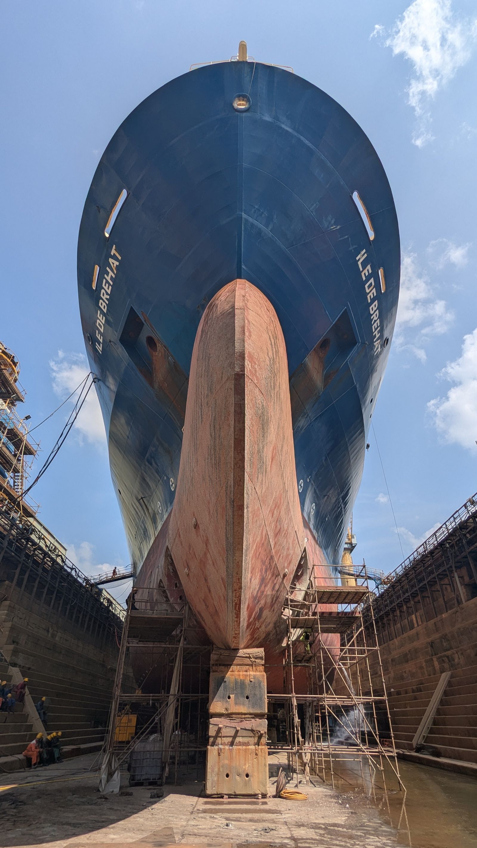 Vessel bow towering over the dry dock on keel blocks